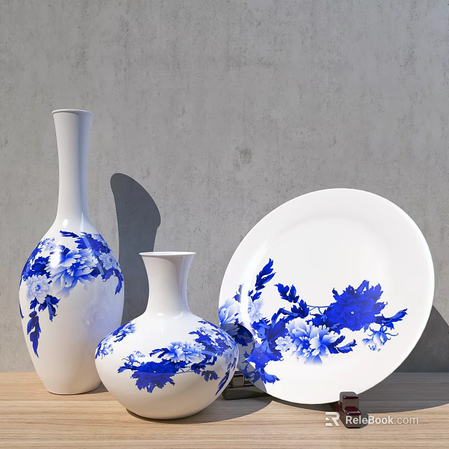 Blue and white ceramic vases with floral patterns and decorative plate 3d model