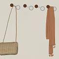 Round Top Metal Base Hooks On Wall With Beige Handbag And Brown Scarf