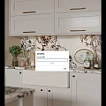 White Kitchen Sink With Brass Faucet Marble Patterned Backsplash And White Cabinets On Kitchen Countertop