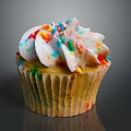 Delicious Cupcake With White Frosting And Colorful Sprinkles On Paper Liner