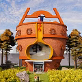 Unique Round Red Brick Guesthouse Building With Trees And Flower Field