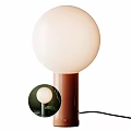 Modern Table Lamp with White Spherical Lampshade Brown Base in Indoor Setting with Green Plants