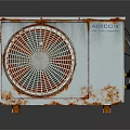 Old Outdoor Air Conditioner Unit Featuring Rusty Body And Fan Grill
