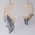Stylish Rattan Hanging Chairs With Round Design Cushions And Gray Blankets