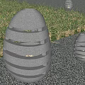 Outdoor Stone Egg Lanterns With Hollow Striped Design And Warm Light On Grass Gravel