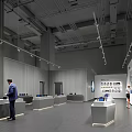 Modern Exhibition Hall Featuring Gray Walls Track Lights Display Counters And People Viewing Exhibits
