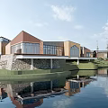 Modern Waterfront Buildings Featuring Red Brick Wooden Structures Glass Windows Green Lawn And Water Reflection
