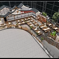 Traditional Roof Open Layout Restaurant With Dining Tables Green Plants And Modern Glass Walls
