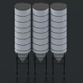 Three Vertical Cylindrical Industrial Storage Tanks With Supporting Frames For Material Storage