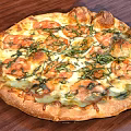 Freshly Baked Pizza Topped with Tomato Basil and Melted Cheese on Crispy Crust