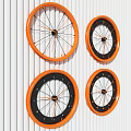 Four Modern Orange And Black Clocks Hanging On White Striped Wall
