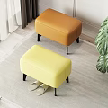 Orange And Yellow Ottoman Stools With Black Legs On Carpet Near Slippers And Green Plant