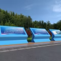 Three Blue Billboards with Green Trees and Red Flowers By Roadside