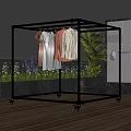 Sturdy Metal Clothes Rack With Wheels Hanging Clothes On Outdoor Balcony With Plants And Sky