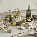 Fresh Limes Pears And Lemons On Marble Tabletop With Decorative Candles Vases And Tableware