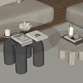 Stylish Glass Top Coffee Table With Black Cylindrical Legs And Decorative Tray Items