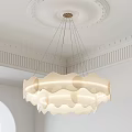 Modern Wave Shaped Cream Colored Chandelier Hanging In Ceiling With Decorative Moldings