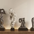Stone Sculptures With Unique Holes And Irregular Shapes On Wooden Tabletop Light Wall With Shadows