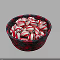 Red and white striped candy arranged in red and black woven basket