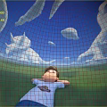 Relaxed Boy Lying on Green Grass With Dinosaur Shaped Clouds in Blue Sky