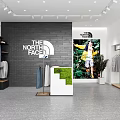 The North Face Clothing Store with Hanging Apparel Poster Display and Green Plants