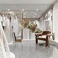 Elegant Bridal Shop with Grey Lace Wedding Dress on Display Platform and Hanging Bridal Gowns