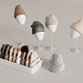Knitted Hats Display Featuring White Mannequin Heads And White Box With Various Colors