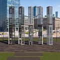 Modern Elevators in Urban Cityscape With Tall Buildings Street Cars and Green Plaza