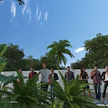 Group of People Standing Outdoors With Green Plants Palm Trees And Blue Sky