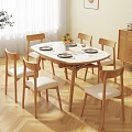 Round White Dining Table Set With Wooden Legs And Six Chairs With White Cushions