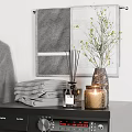 Black Front Load Washing Machine With Gray Robe Laundry Basket Wooden Table And Towels
