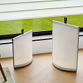 Two Modern Curved White Floor Lamps By Window With Natural Light In Home Interior
