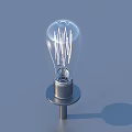 Transparent Light Bulb With Visible Filament And Metal Base On Blue Background