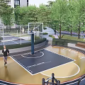 Outdoor Basketball Court With Golden Black Surface Design And Surrounding Green Trees And Hoop 3d model