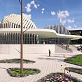 Modern Landmark Building With Unique Curved Roof Near Road Green Area Trees Mountains And Blue Sky