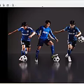 Four men in blue jerseys playing football together each with a soccer ball