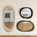 Oval Mirrors in Beige Black Brown Hanging on White Wall With Wooden Floor Reflecting Artwork