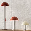 Red and White Dome Shaped Table Lamps on Wooden Shelf with Light Textured Wall