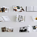 Multiple Open Magazines Showcasing Photos Text And Stylish Page Layouts On Clean White Background