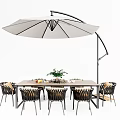 Outdoor Table and Chair Set Featuring Woven Chairs Wooden Tabletop and Large White Cantilever Umbrella