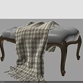 Upholstered Footstool With Soft Blue Cushion Wooden Carved Legs And Houndstooth Fringe Blanket
