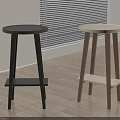 Two Modern Bar Stools With Round Tops Light And Dark Wooden Legs In Room