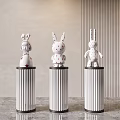 White Rabbit Sculptures With Red Polka Dots On Decorative Pedestals In Modern Room