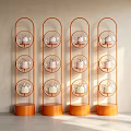 Elegant Display Window with Orange Curved Shelves Three Circular Glass Tiers Pink Teapots Light Wall