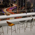 Modern Bar Counter With High Stools And City Night View Through Large Windows
