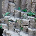 Natural Stone Rock Structures With Green Plants Growing In Crevices Design
