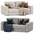 Light Beige and Gray Two Seater Sofa with Brown Black Pillows and Beige Blue Blanket
