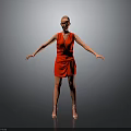 Woman In Red Dress Standing With Arms Outstretched Against Gray Background In High Heels