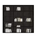 Modern Dark Wood Bookcase With Multiple Compartments Stacked Books And Decorative Items
