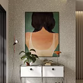 Floor lamp with silver head and red wire against gray wall near green plant